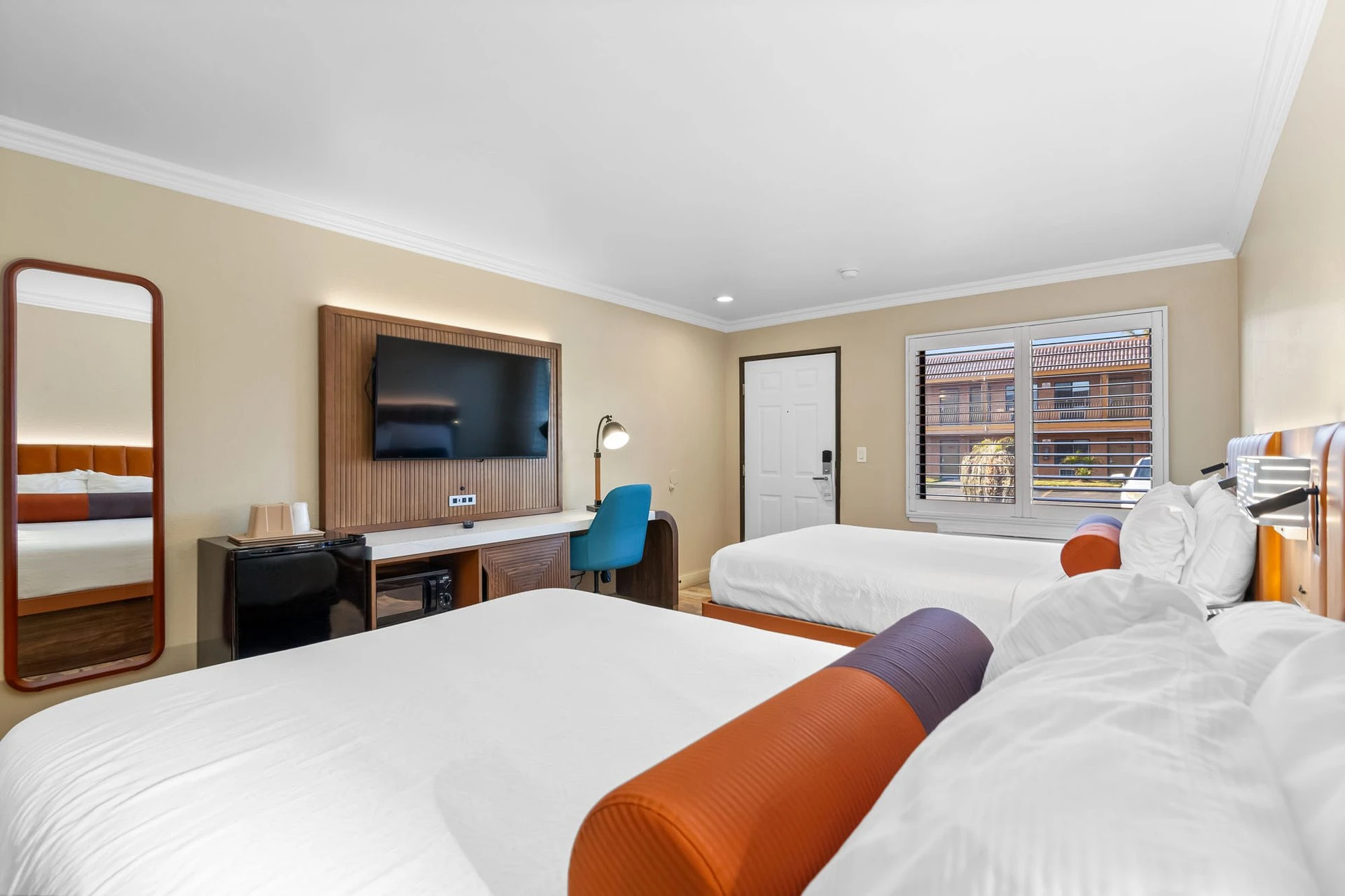 Two Queen Deluxe Room view showing beds and workspace